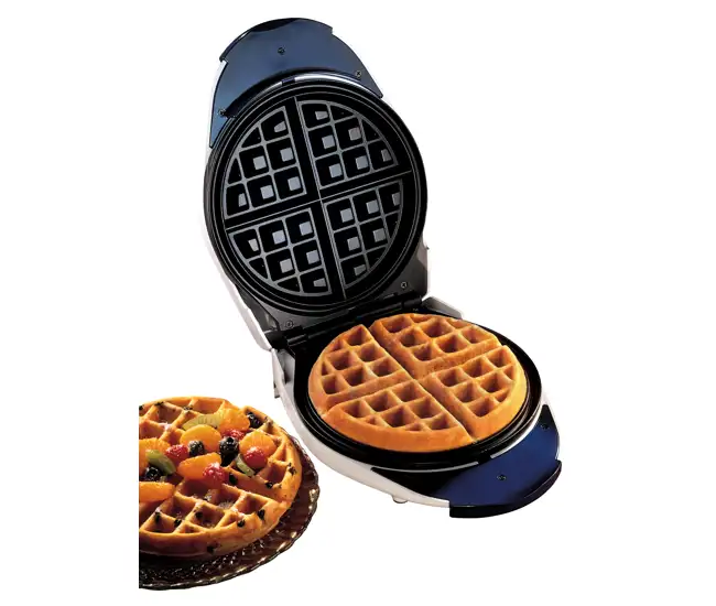 Freshly made homemade waffles from a classic waffle maker, with one plated and ready to enjoy.